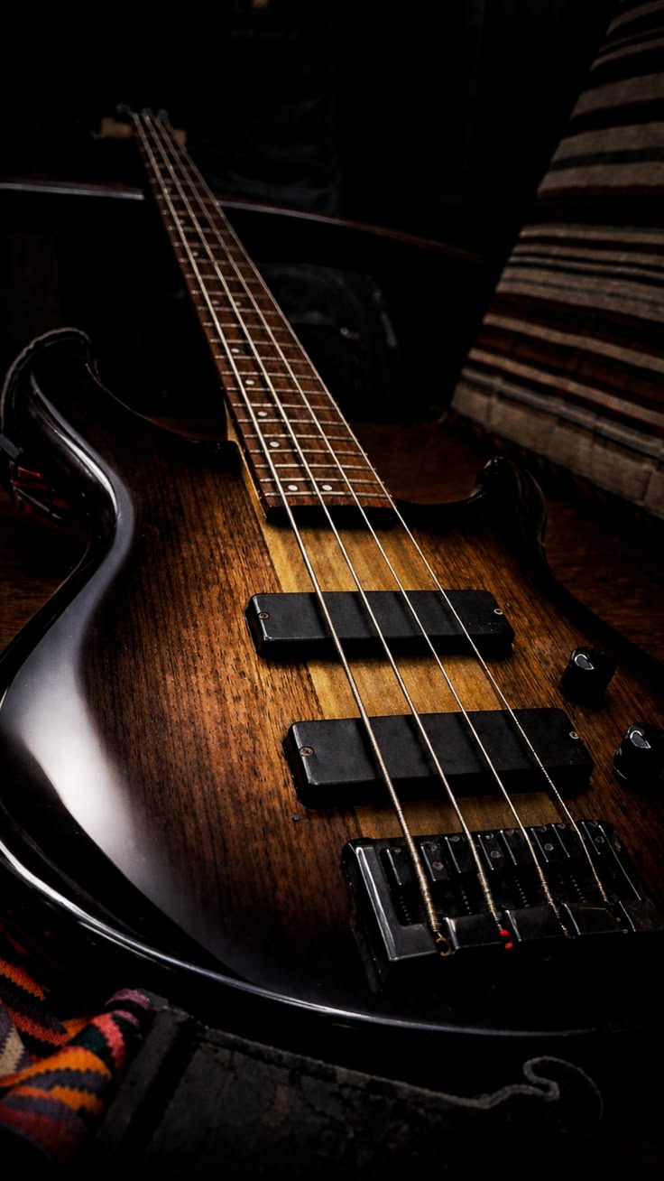 An electric bass guitar in low light